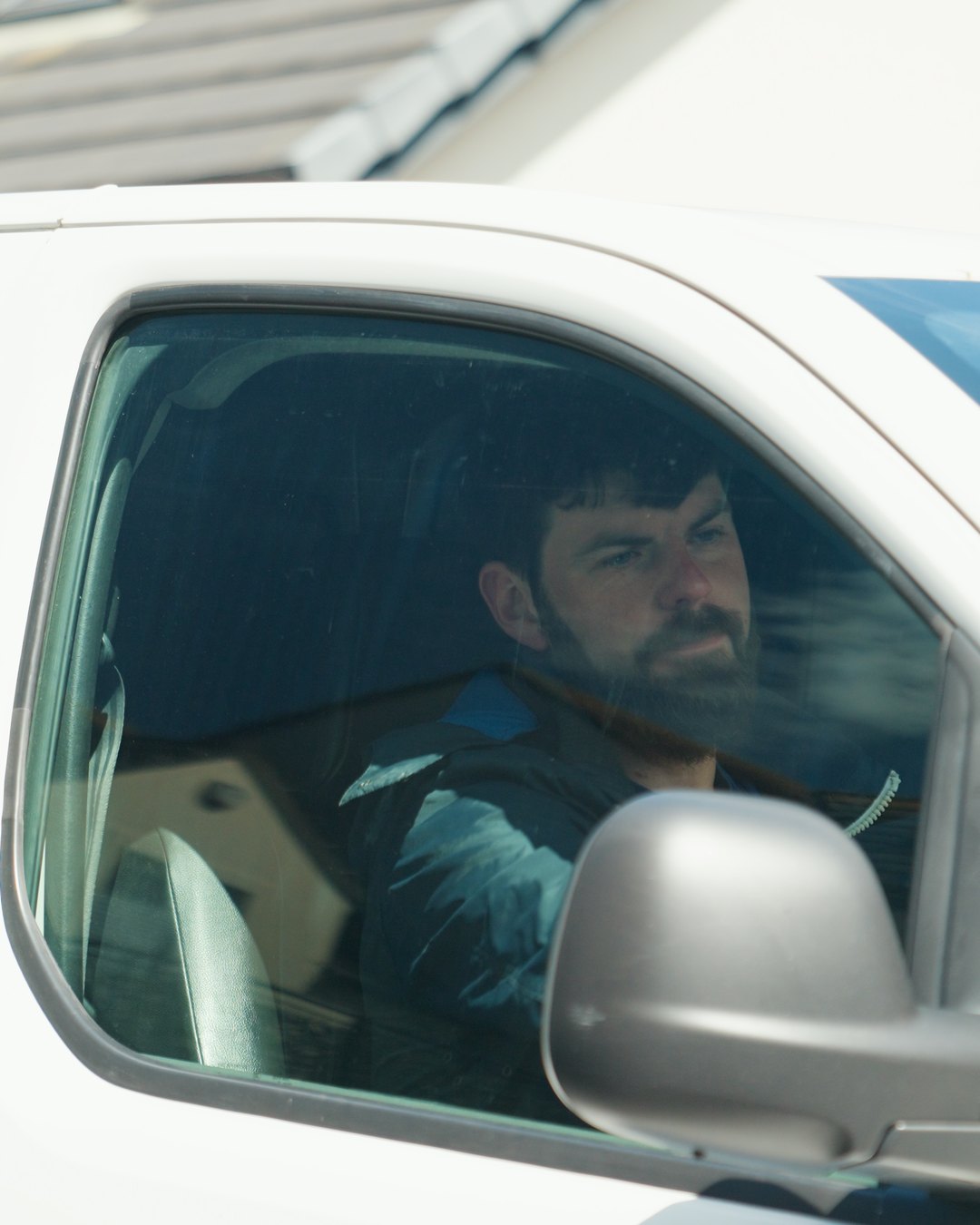 Heating engineer in the driver’s seat of his van, on the way to the next job